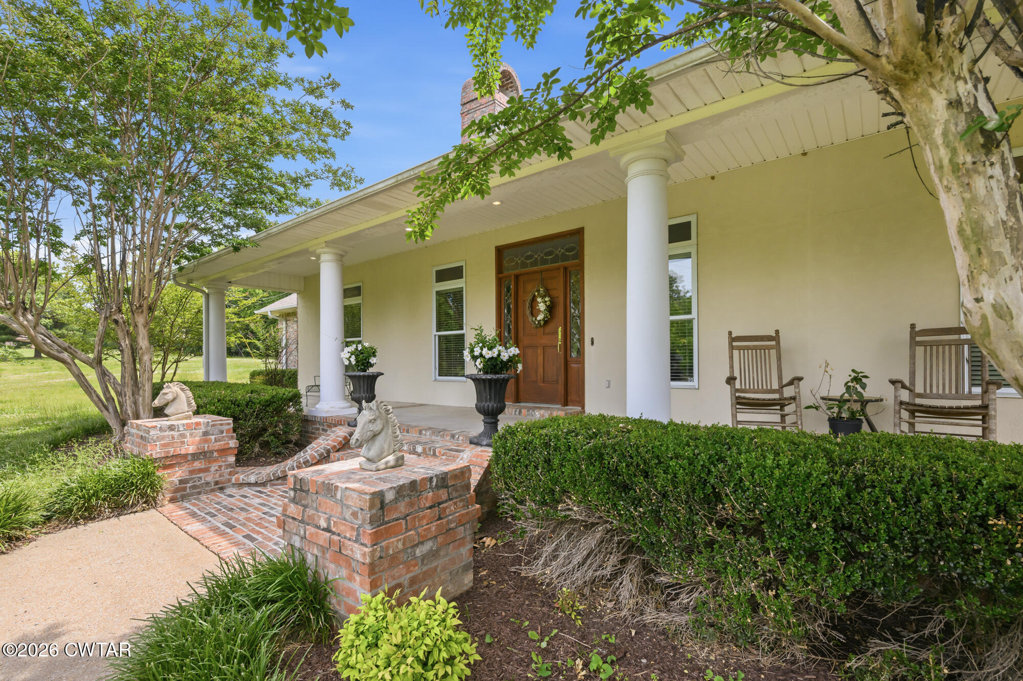300 Harrison Road Dyersburg, TN 38024 - Photo 3 of 27 a view of a patio with couches table and chairs and potted plants