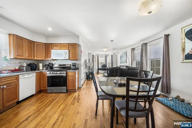 a kitchen with a table chairs stove and cabinets