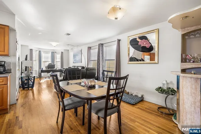 a dining room with furniture and wooden floor