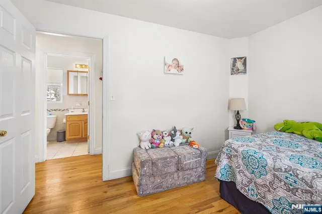 a bedroom with a bed and a view of kitchen
