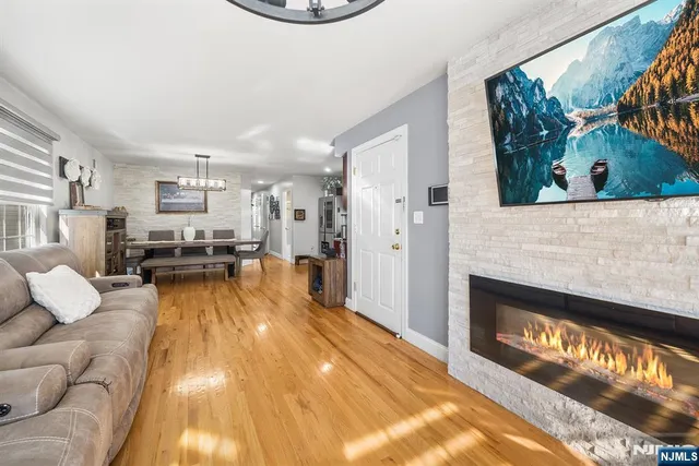 a view of a living room with furniture and a fireplace