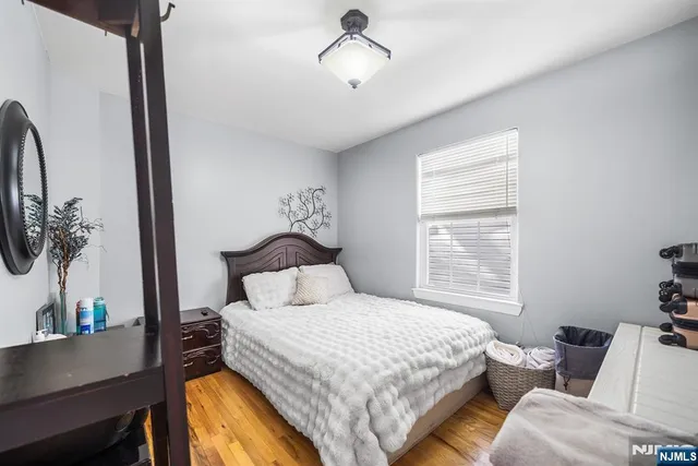 a bedroom with a large bed and a chandelier