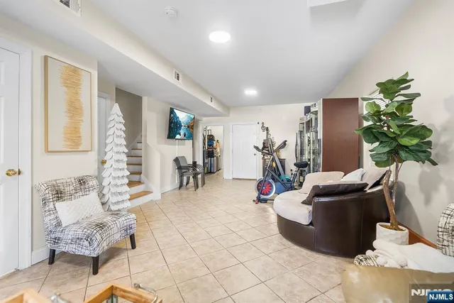 a living room with furniture and a potted plant