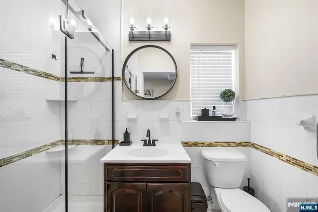 a bathroom with a toilet a sink and a mirror