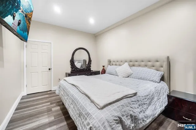 a large bed sitting in a bedroom next to a window