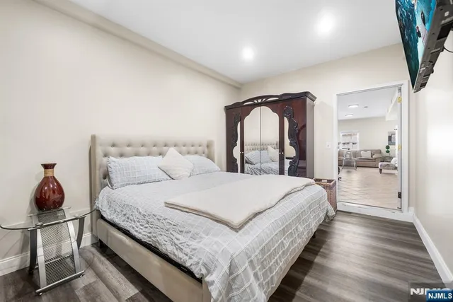a bedroom with a large bed and a potted plant