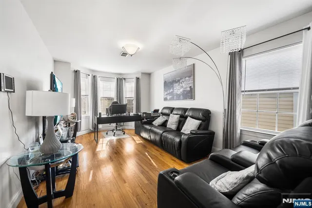 a living room with furniture and a lamp