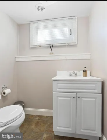a bathroom with a sink a toilet and vanity
