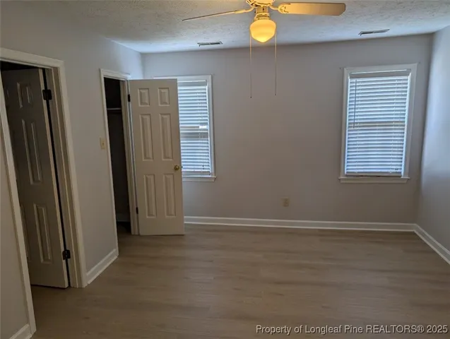 an empty room with window and closet