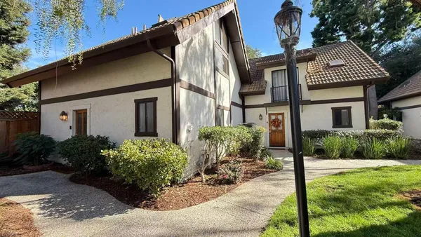 a front view of house with yard and outdoor seating