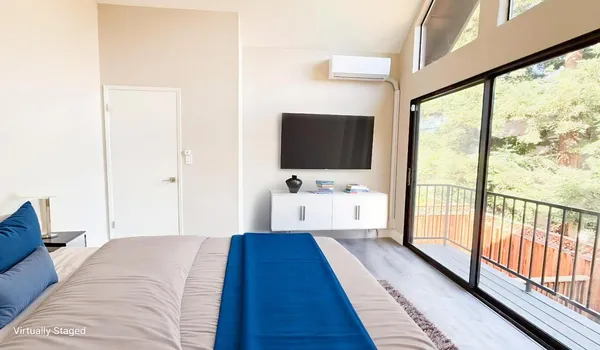 a bedroom with a bed and a flat screen tv