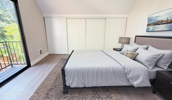 a bedroom with a bed and a large window