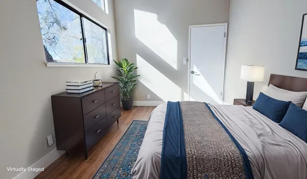 a bed room with a bed and a potted plant