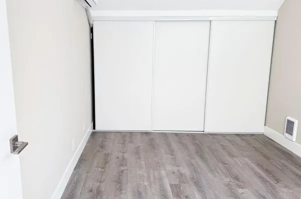 a view of a room with wooden floor