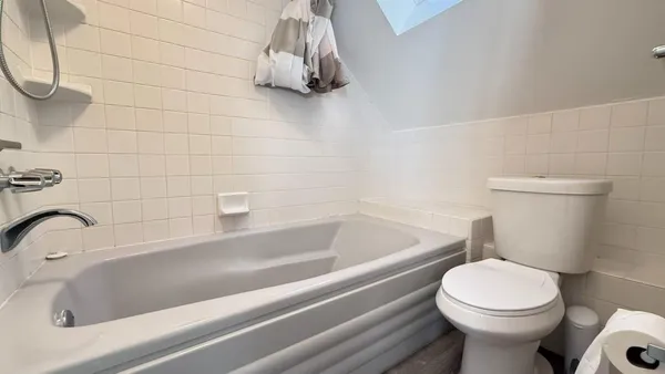 a bathroom with a sink a toilet and bathtub