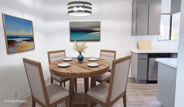 a dining room with furniture and wooden floor