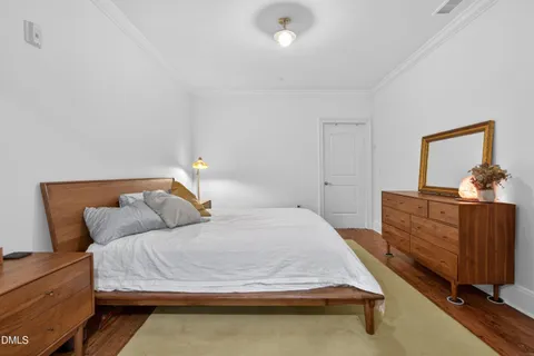 a bedroom with a bed and cabinet