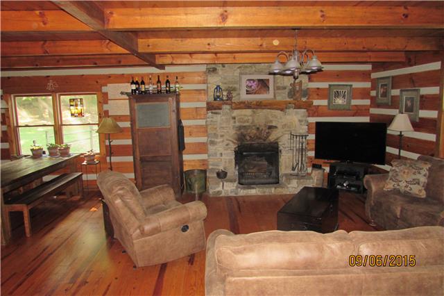 6169 Red River School Road Portland, TN 37148 - Photo 8 of 20 a living room with furniture a flat screen tv and a fireplace