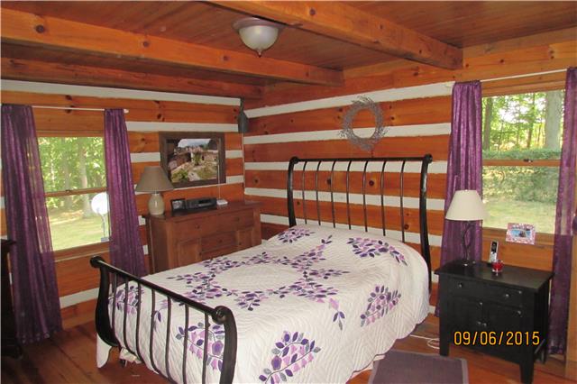 6169 Red River School Road Portland, TN 37148 - Photo 9 of 20 a bed sitting in a bedroom next to a window