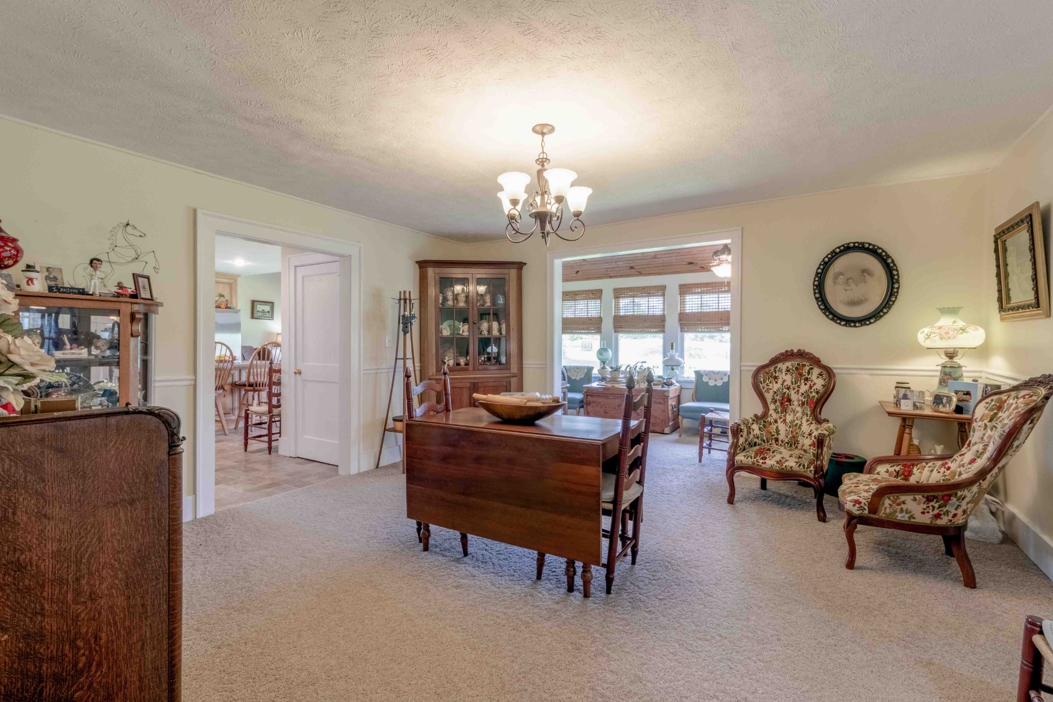 1780 Hickory Point Road Clarksville, TN 37043 - Photo 39 of 50 a living room with furniture a chandelier a large window and a clock
