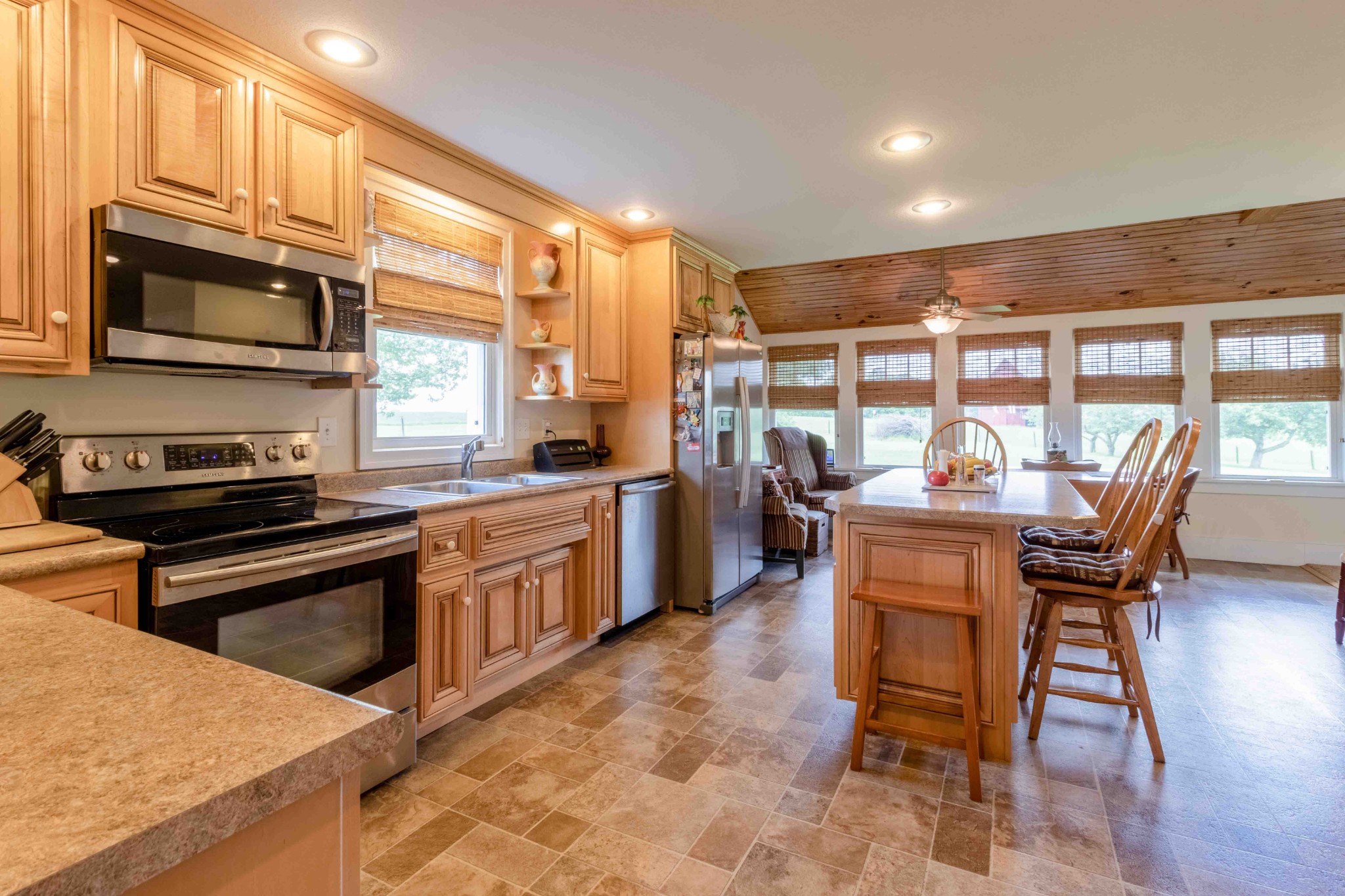1780 Hickory Point Road Clarksville, TN 37043 - Photo 45 of 50 a kitchen with stainless steel appliances kitchen island granite countertop a table chairs sink and cabinets