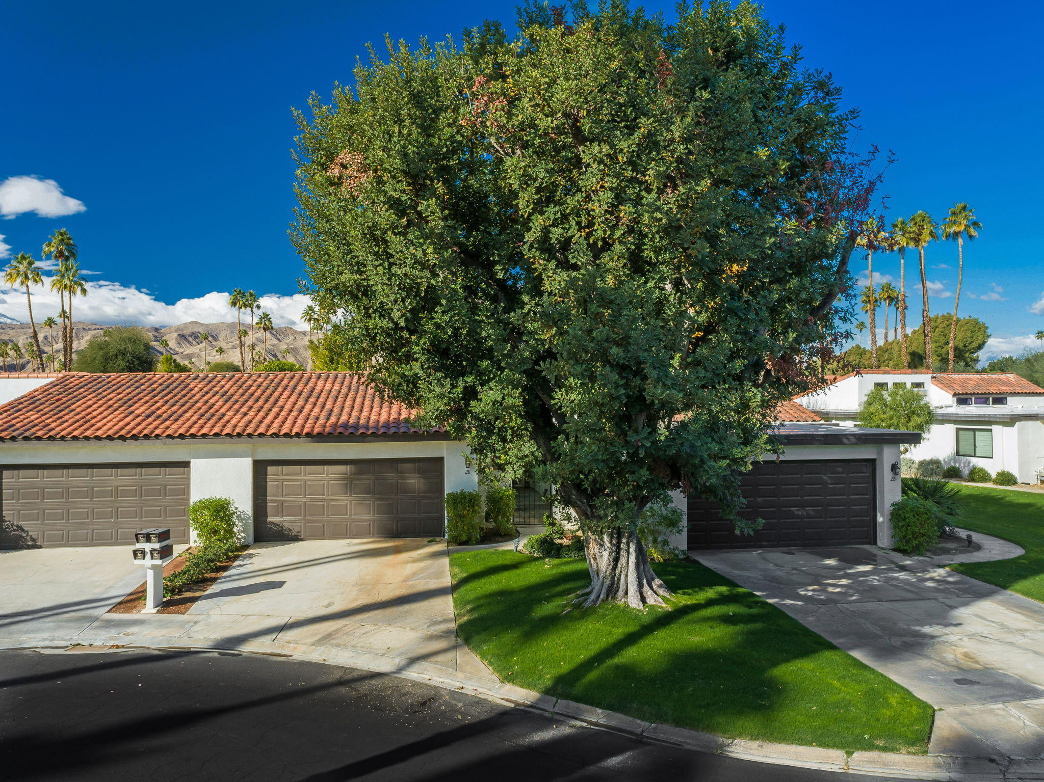 28 Palomas Drive Rancho Mirage, CA 92270 - Photo 2 of 26 a front view of a house with a garden and yard