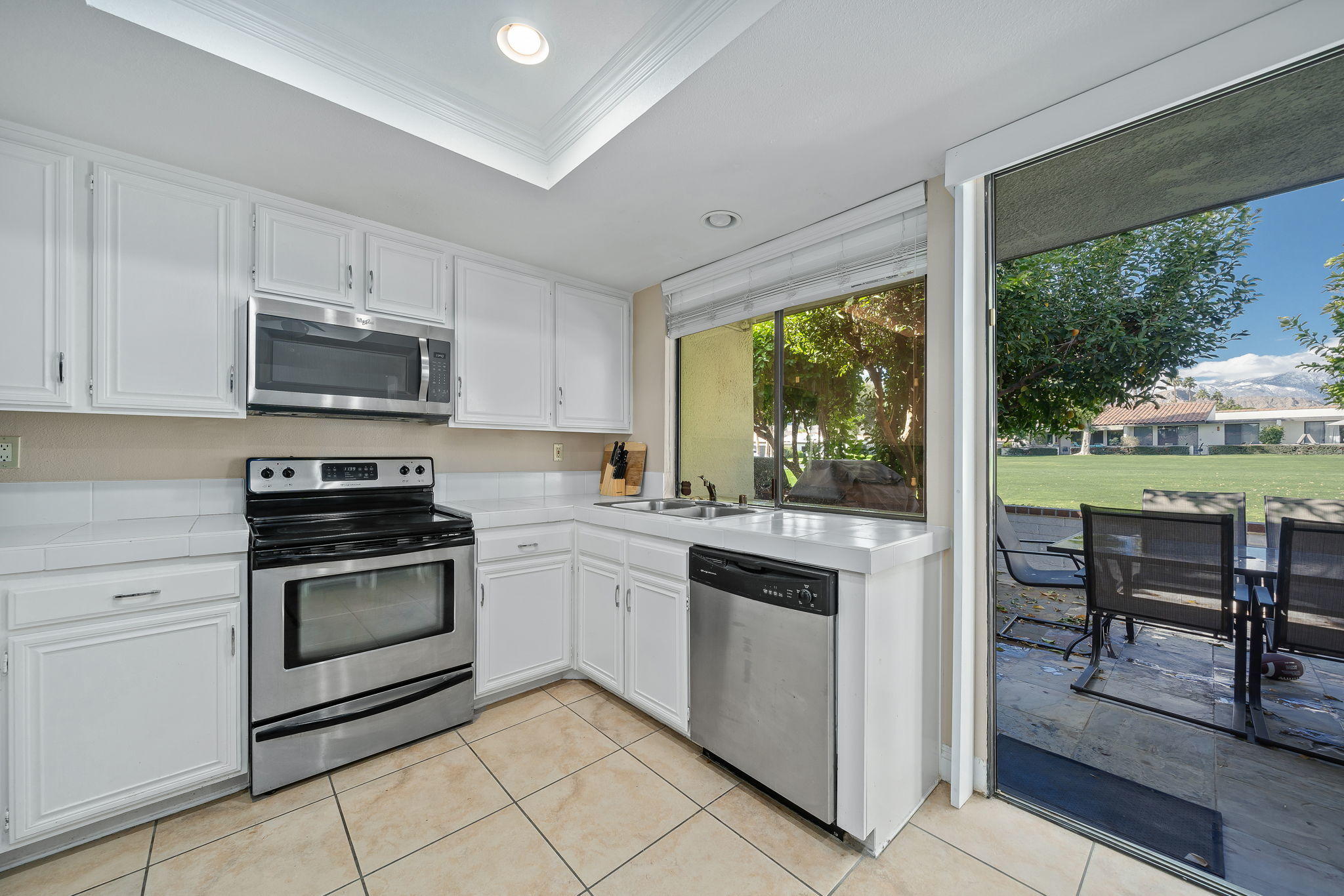 28 Palomas Drive Rancho Mirage, CA 92270 - Photo 12 of 26 a kitchen with stainless steel appliances granite countertop a stove a sink and a microwave