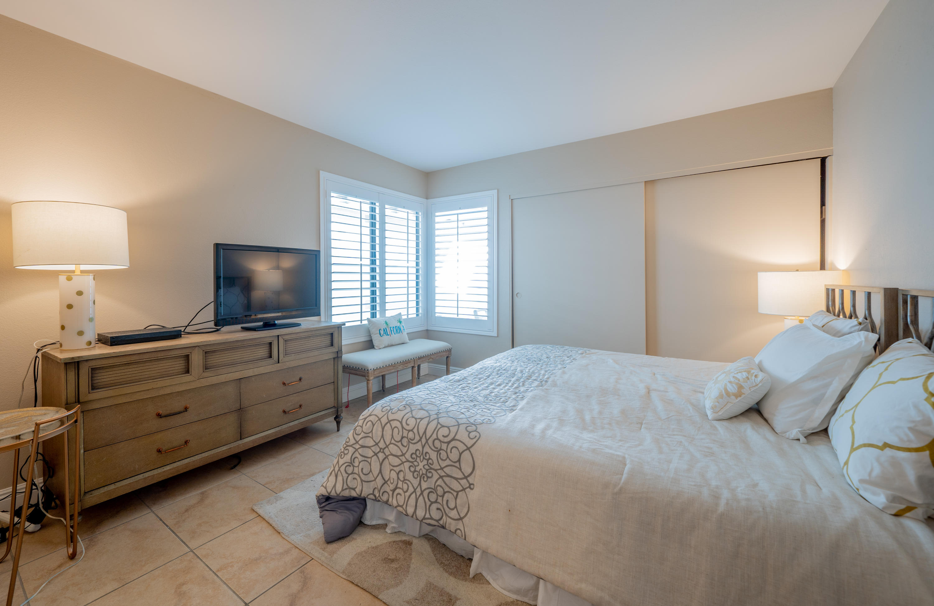 28 Palomas Drive Rancho Mirage, CA 92270 - Photo 24 of 26 a bedroom with a bed and a flat screen tv