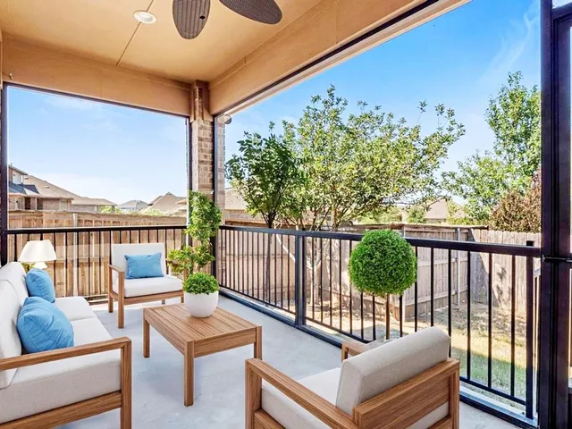 a balcony with furniture and wooden floor