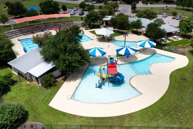 an aerial view of a house with yard swimming pool and outdoor seating