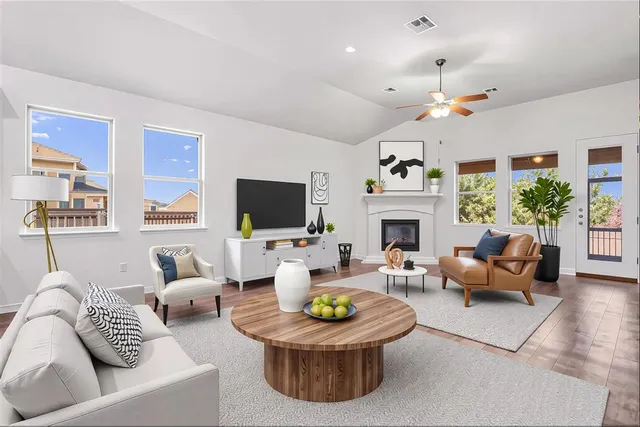 a living room with furniture a fireplace and a flat screen tv