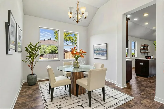 a view of a dining room with furniture and a potted plant