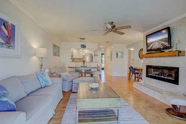 a living room with furniture a couch and a chandelier