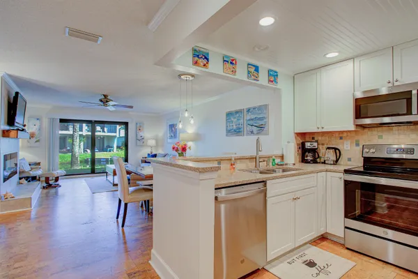 a kitchen with stainless steel appliances a stove microwave and sink