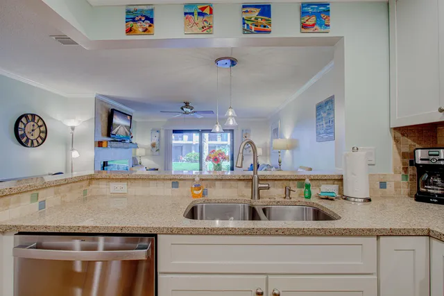 a living room with furniture and a large window with wooden floor