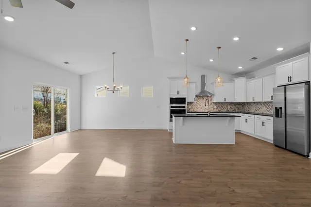 a large kitchen with kitchen island a sink stainless steel appliances and cabinets