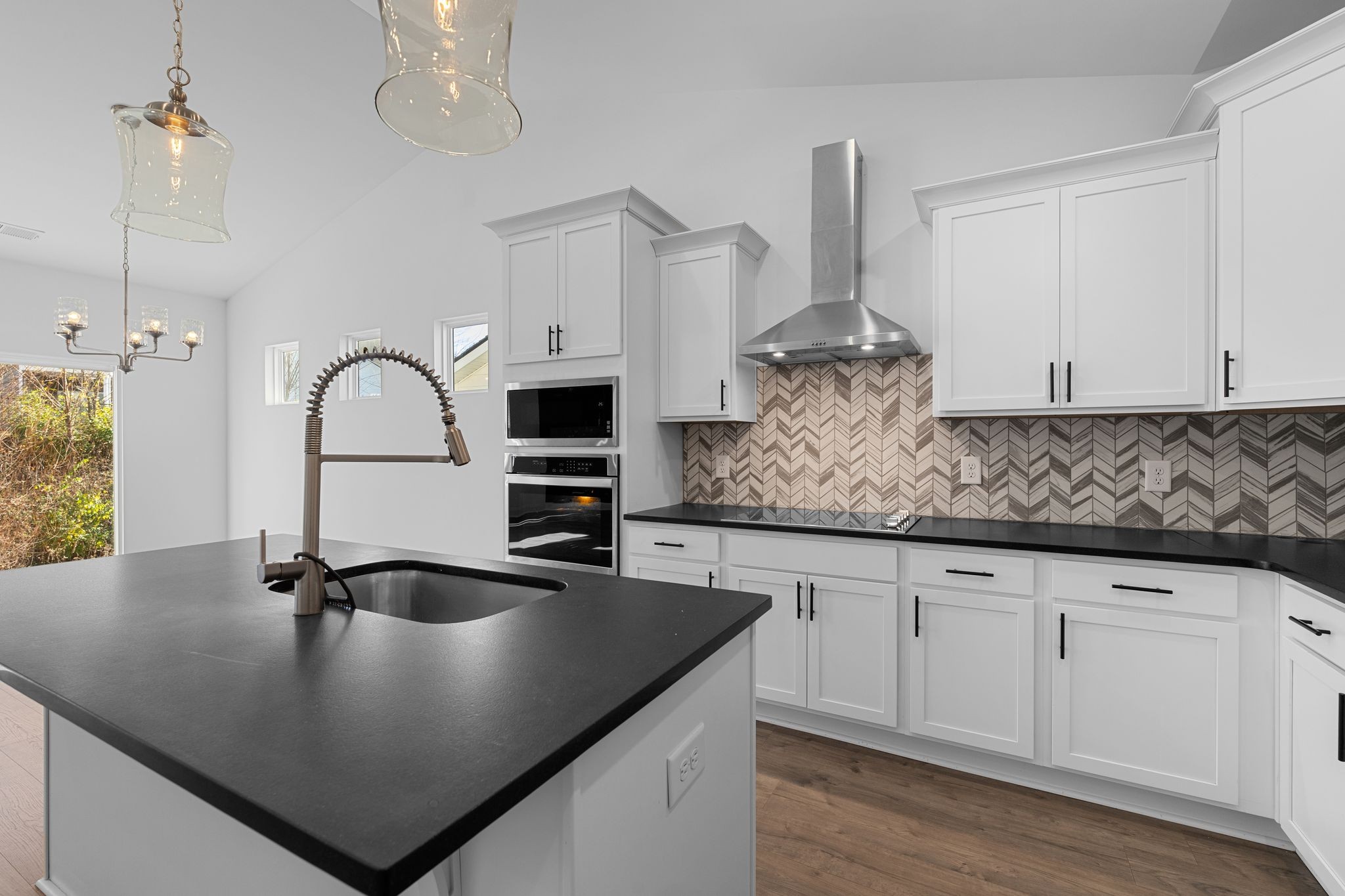 9265 Thomason Trail Antioch, TN 37013 - Photo 15 of 35 a kitchen with stainless steel appliances granite countertop a sink a stove and white cabinets
