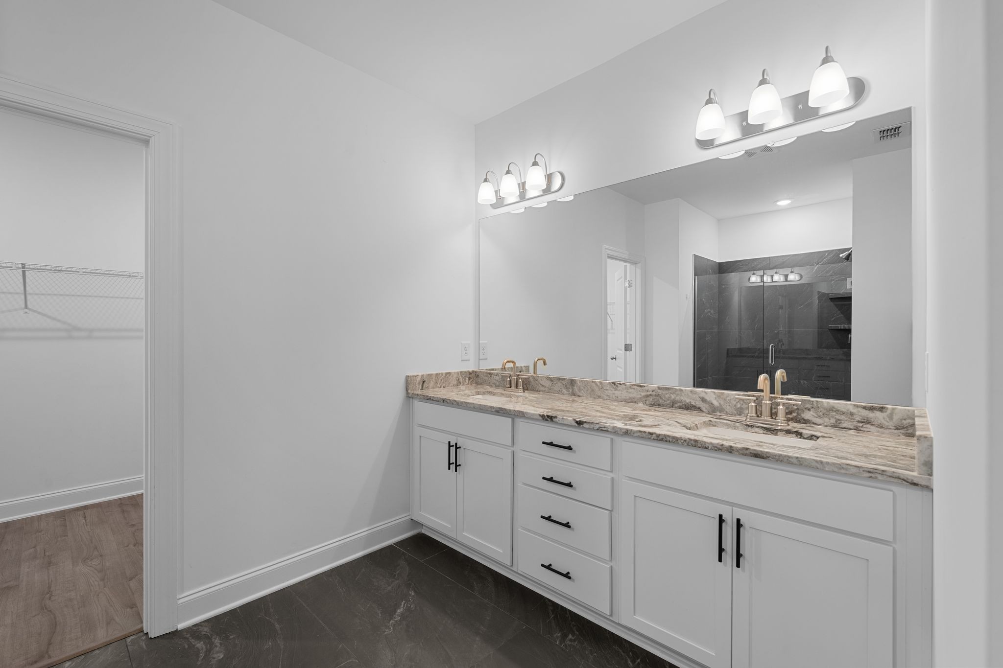 9265 Thomason Trail Antioch, TN 37013 - Photo 19 of 35 a bathroom with a granite countertop sink a large mirror and vanity