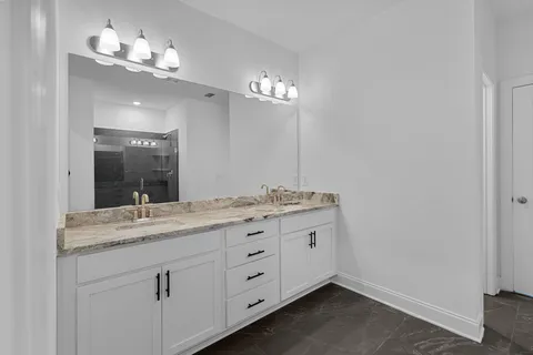 a bathroom with a sink vanity and a mirror