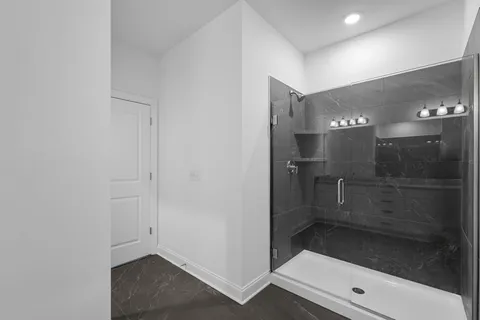 a bathroom with a glass shower door
