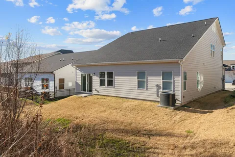a view of a house with snow on the side of the road