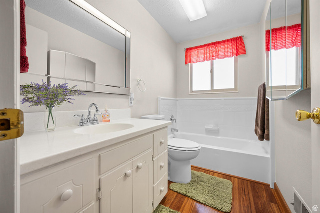 2298 West 800 North Clinton, UT 84015 - Photo 8 of 53 Bathroom with vanity, dark wood finished floors, and a garden tub