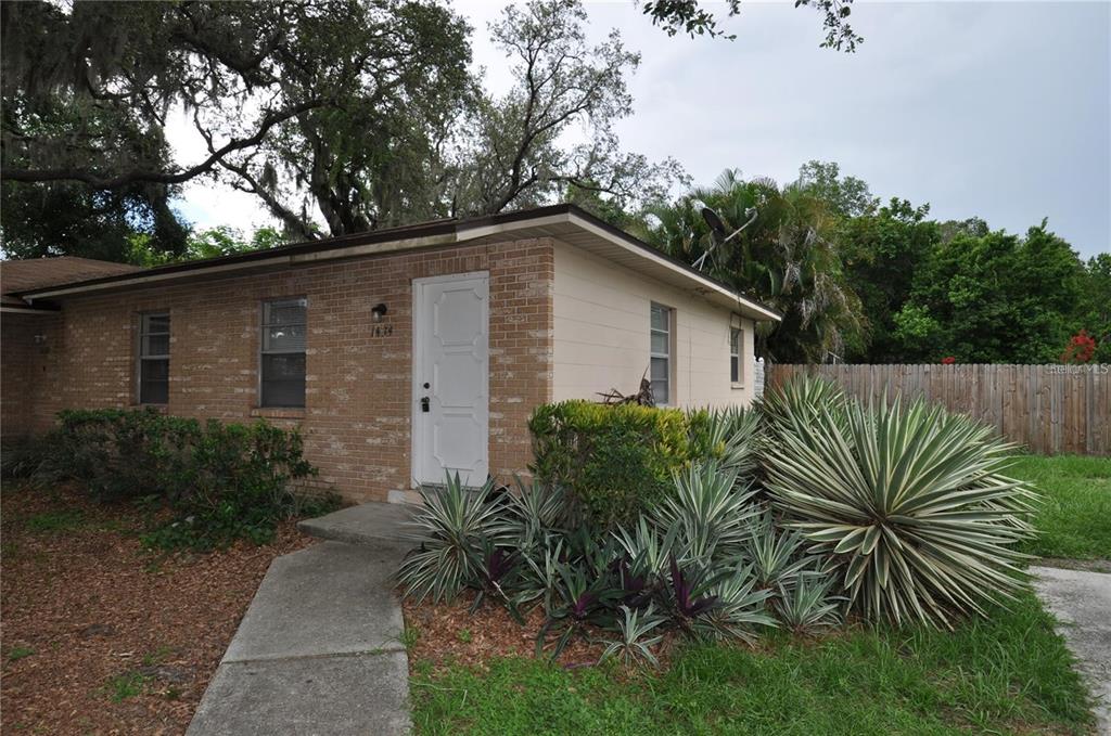 1434 East Fern Road, Unit 1434 Lakeland, FL 33801 - Photo 1 of 13 a house that has a tree in front of it