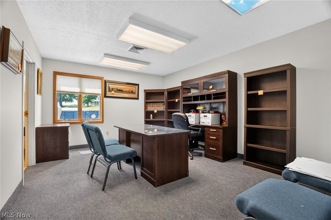 224 Garford Road Geneva, OH 44041 - Photo 20 of 50 Recessed lighting, wood-finish window trim, and a built-in wood-finish desk with integrated shelving