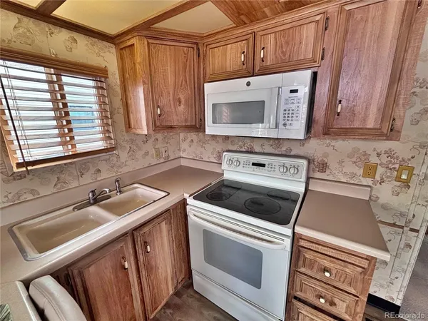 a kitchen with cabinets appliances and a sink