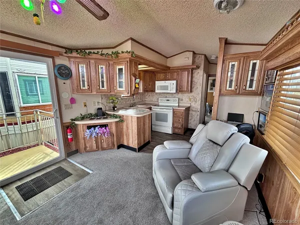 a living room with furniture pool table and chairs