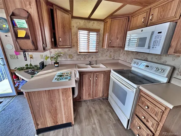 a kitchen with a sink a stove and cabinets