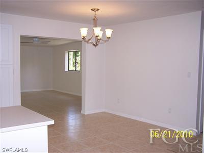 9147 Frank Road Fort Myers, FL 33967 - Photo 4 of 7 a view of a room with a chandelier fan and wooden floor