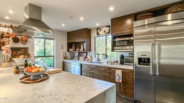 a kitchen with a stove and a wooden floor