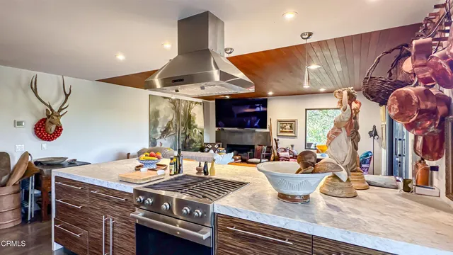a view of a dining room with furniture a chandelier and wooden floor